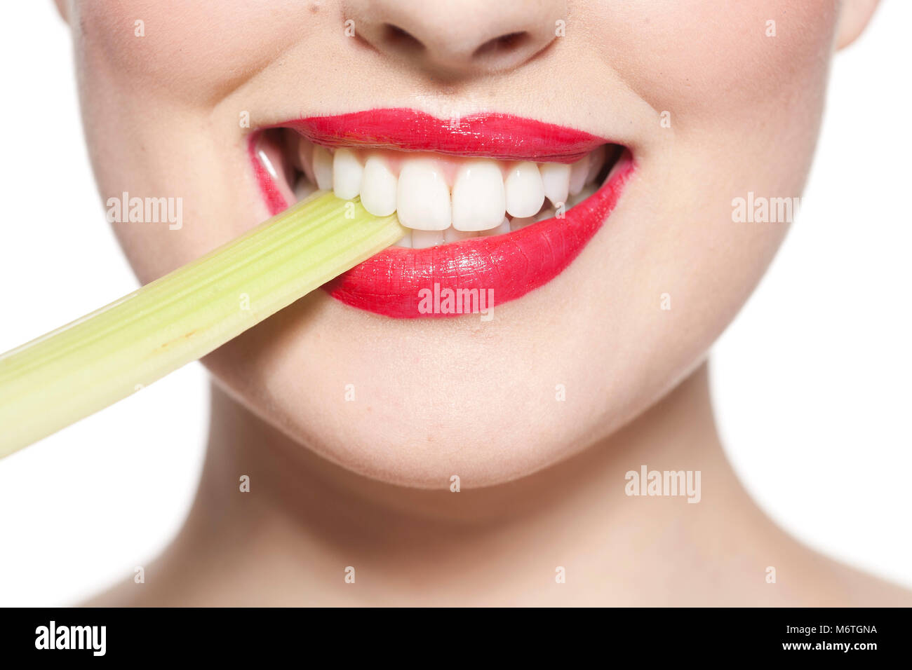 Close up of woman's mouth with celery stick Stock Photo