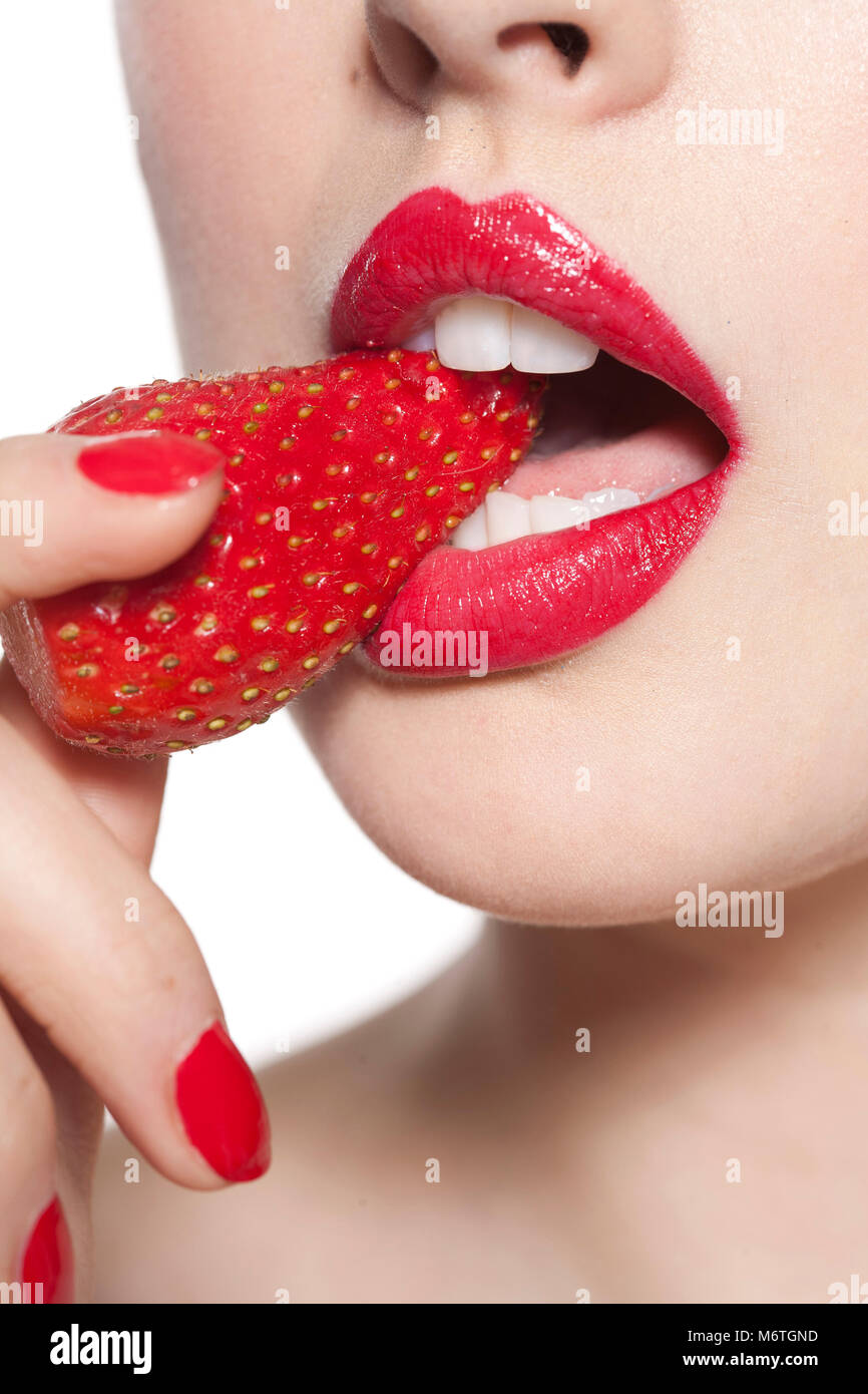 Close up of woman's mouth with strawberry Stock Photo