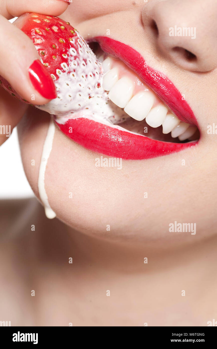 Close up woman's mouth with strawberry and cream Stock Photo