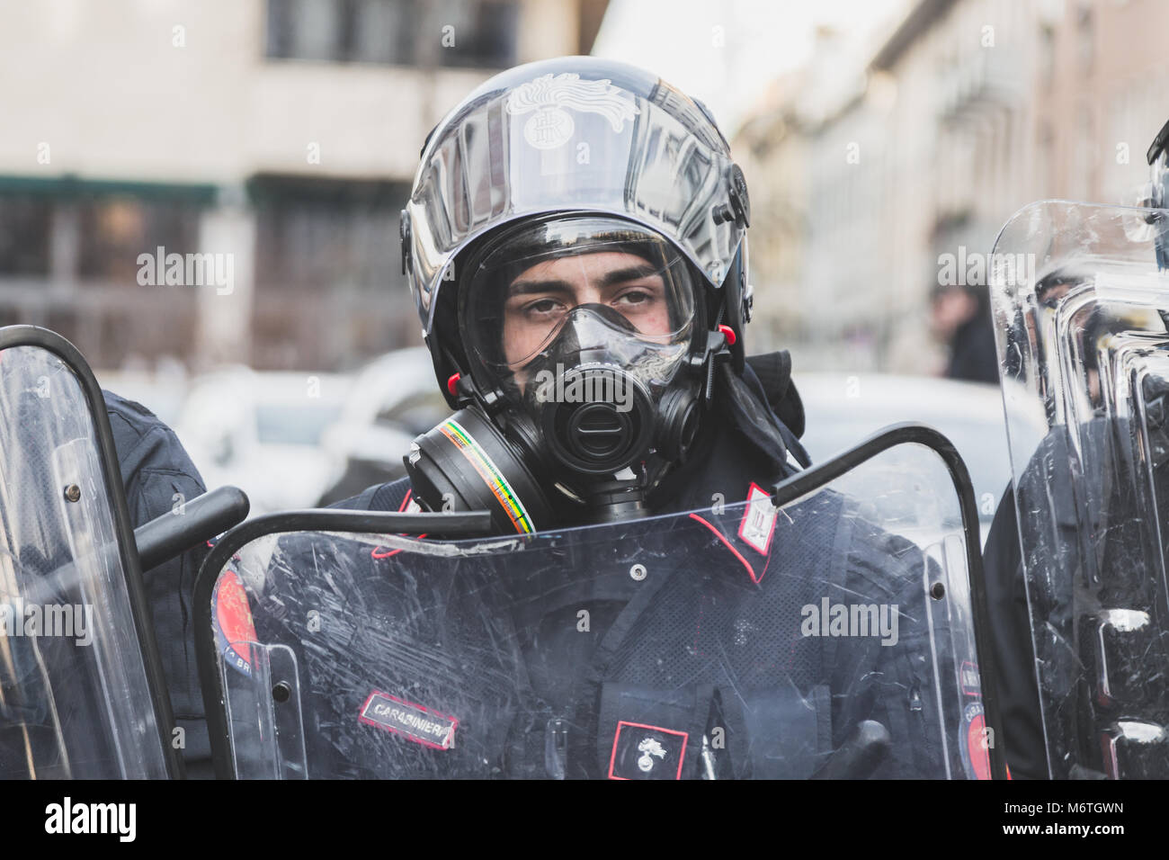 MILAN, ITALY - FEBRUARY 24: Portrait of a riot policeman wearing gas mask during an anti-fascist march in the city streets on FEBRUARY 24, 2018 in Mil Stock Photo