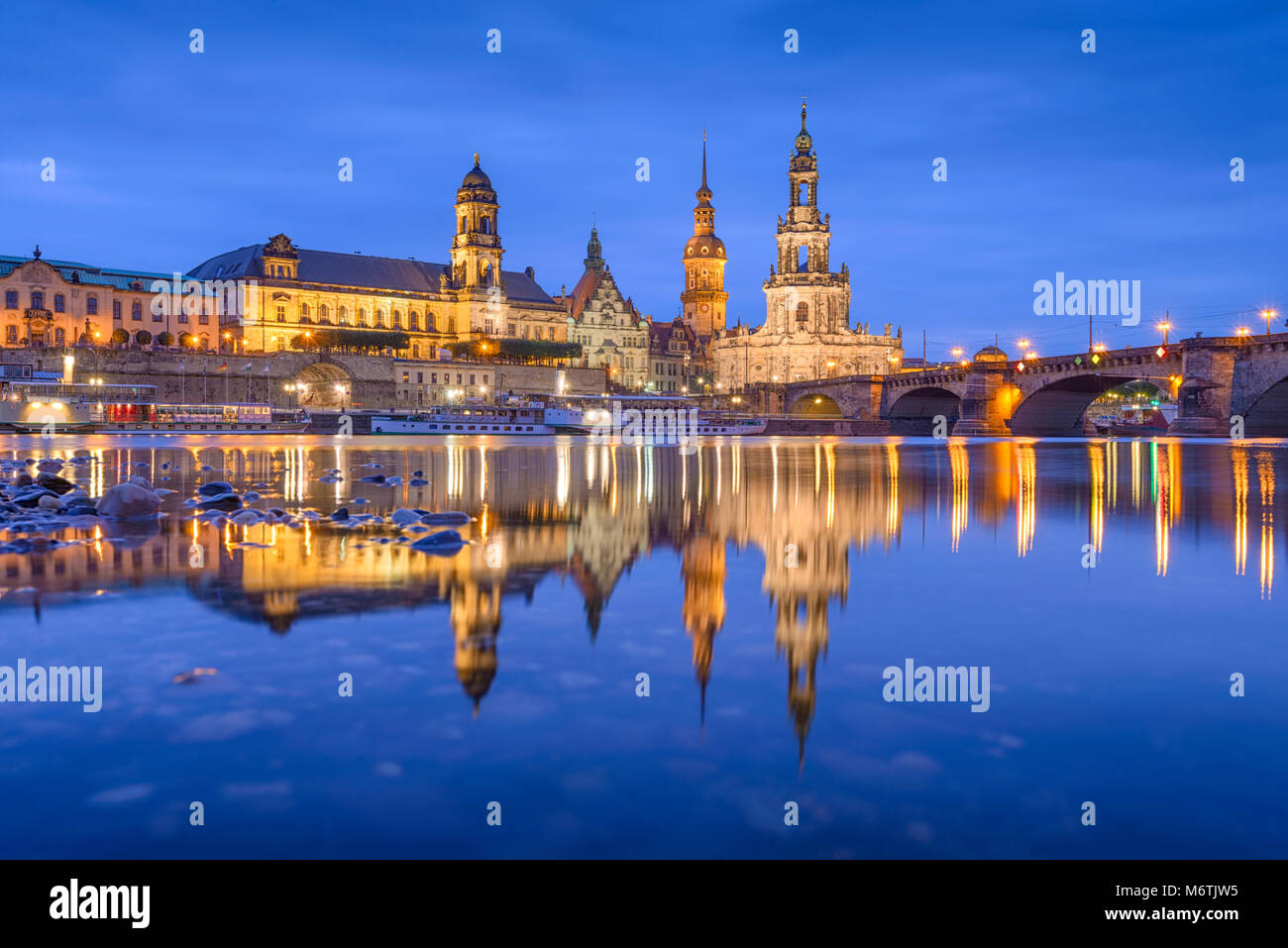 Dresden, Germany classical cathedrals and spires on The Elbe River at night. Stock Photo