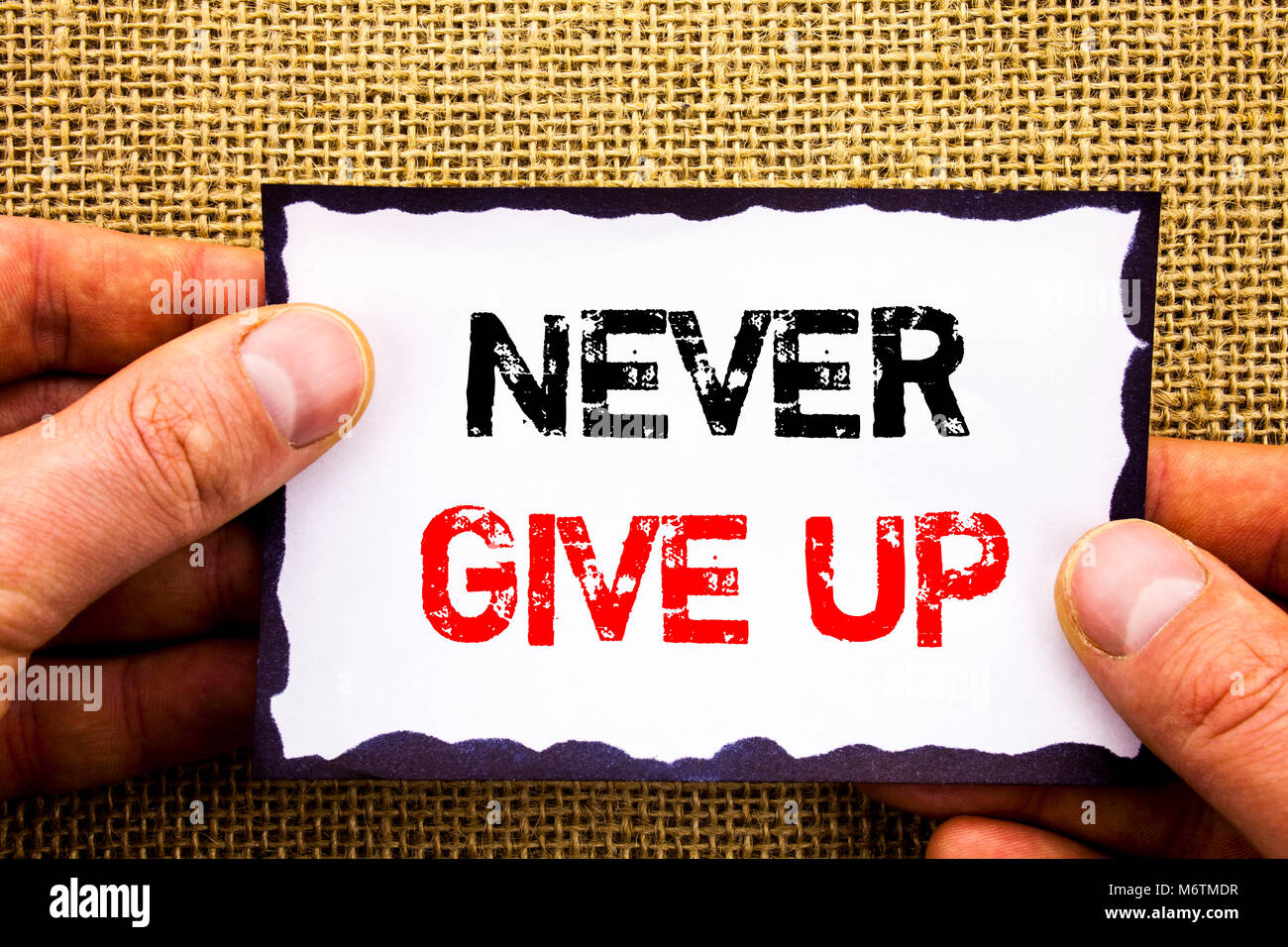 Writing text showing  Never Give Up. Concept meaning Motivation Quote For Success Achievement Challenge written Sticky Note Paper Holding Hand with Fi Stock Photo
