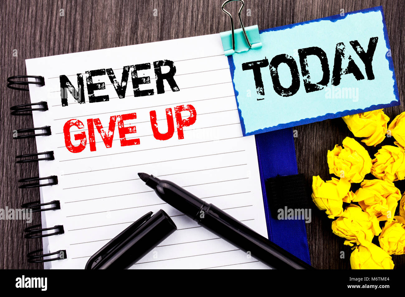 Writing text showing  Never Give Up. Business photo showcasing Motivation Quote For Success Achievement Challenge written notebook book paper the wood Stock Photo