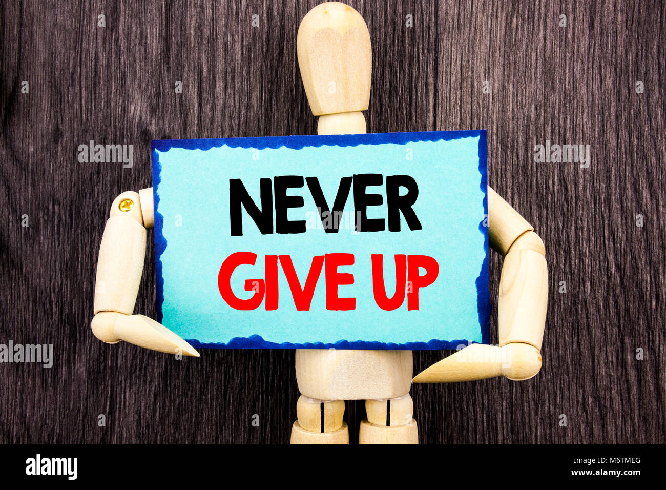 Writing text showing  Never Give Up. Concept meaning Motivation Quote For Success Achievement Challenge written Sticky Note Holding By Sculpture the w Stock Photo