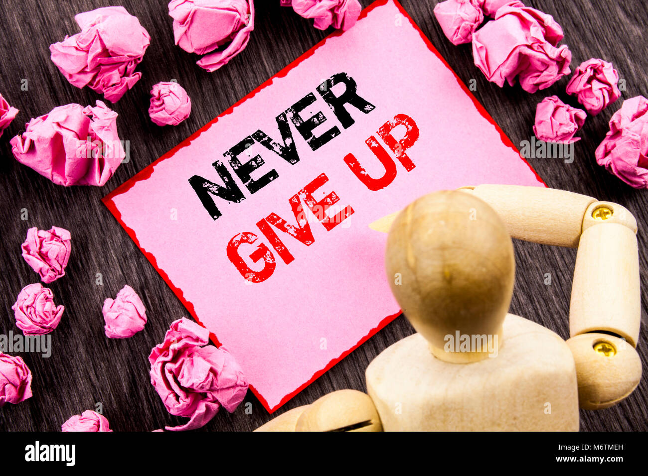 Conceptual hand text showing Never Give Up. Concept meaning Motivation Quote For Success Achievement Challenge written Sticky Note Holding By Sculptur Stock Photo