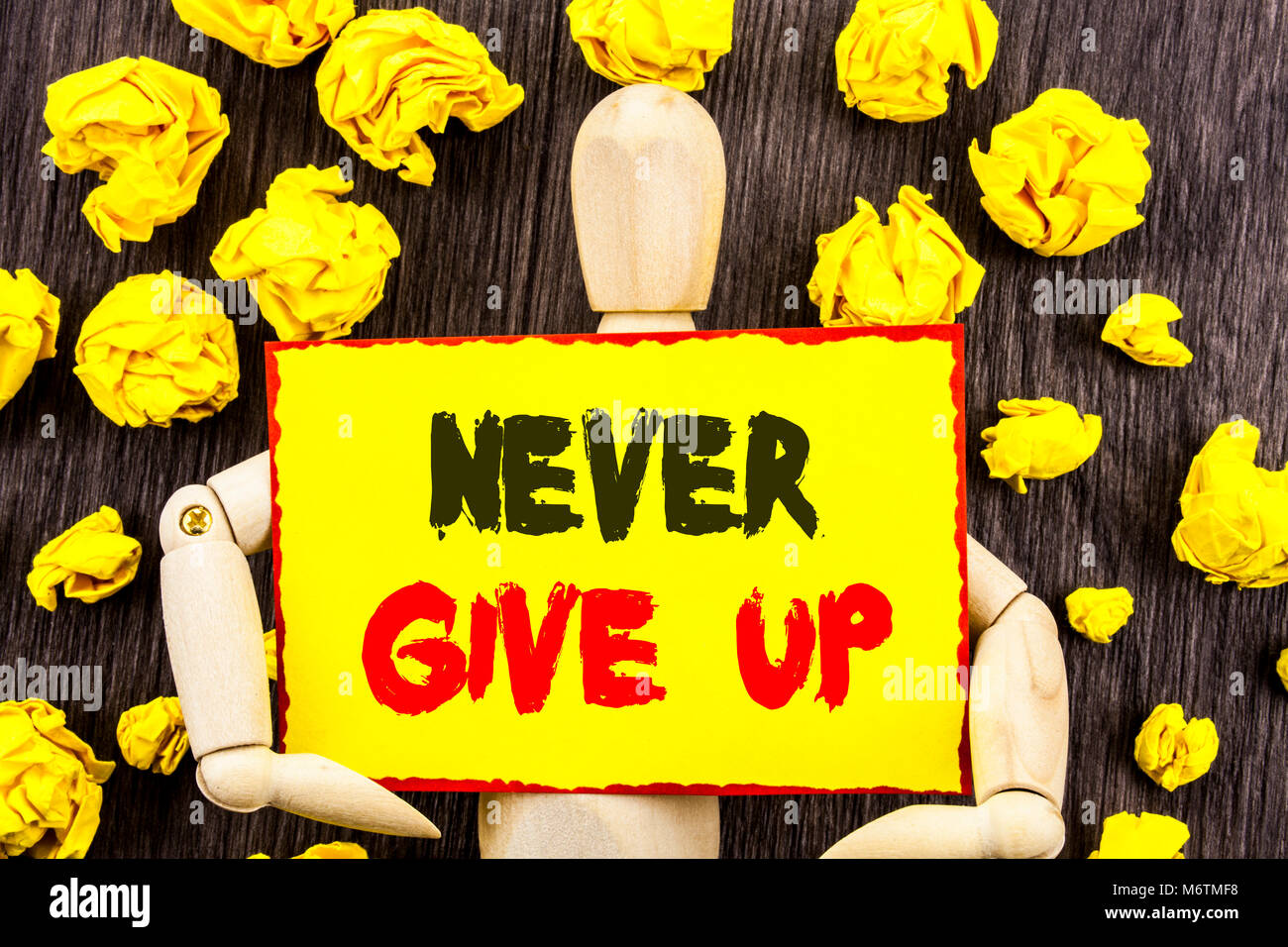 Announcement text showing Never Give Up. Concept meaning Motivation Quote For Success Achievement Challenge written Sticky Note Holding By Sculpture t Stock Photo