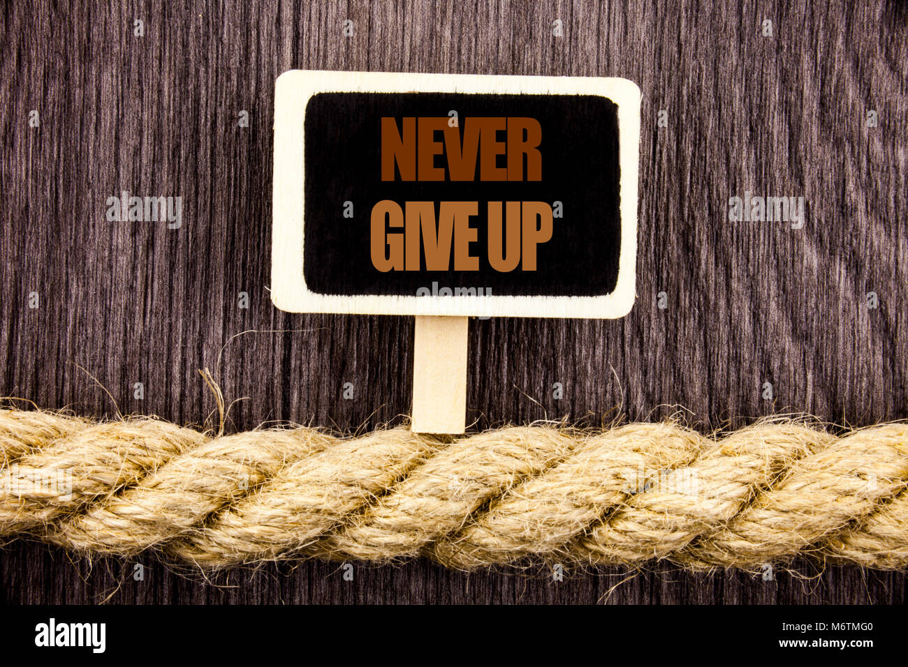 Conceptual writing text showing Never Give Up. Business photo showcasing Motivation Quote For Success Achievement Challenge written Blackboard Hanging Stock Photo