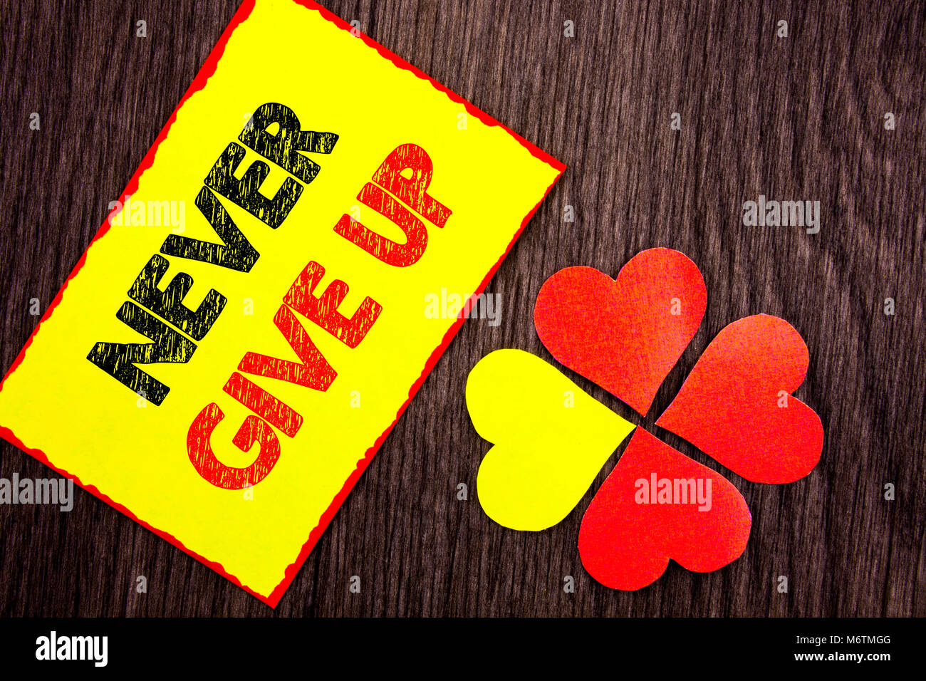 Text showing Never Give Up. Business photo showcasing Motivation Quote For Success Achievement Challenge written Sticky Note Paper with Love Heart Nex Stock Photo