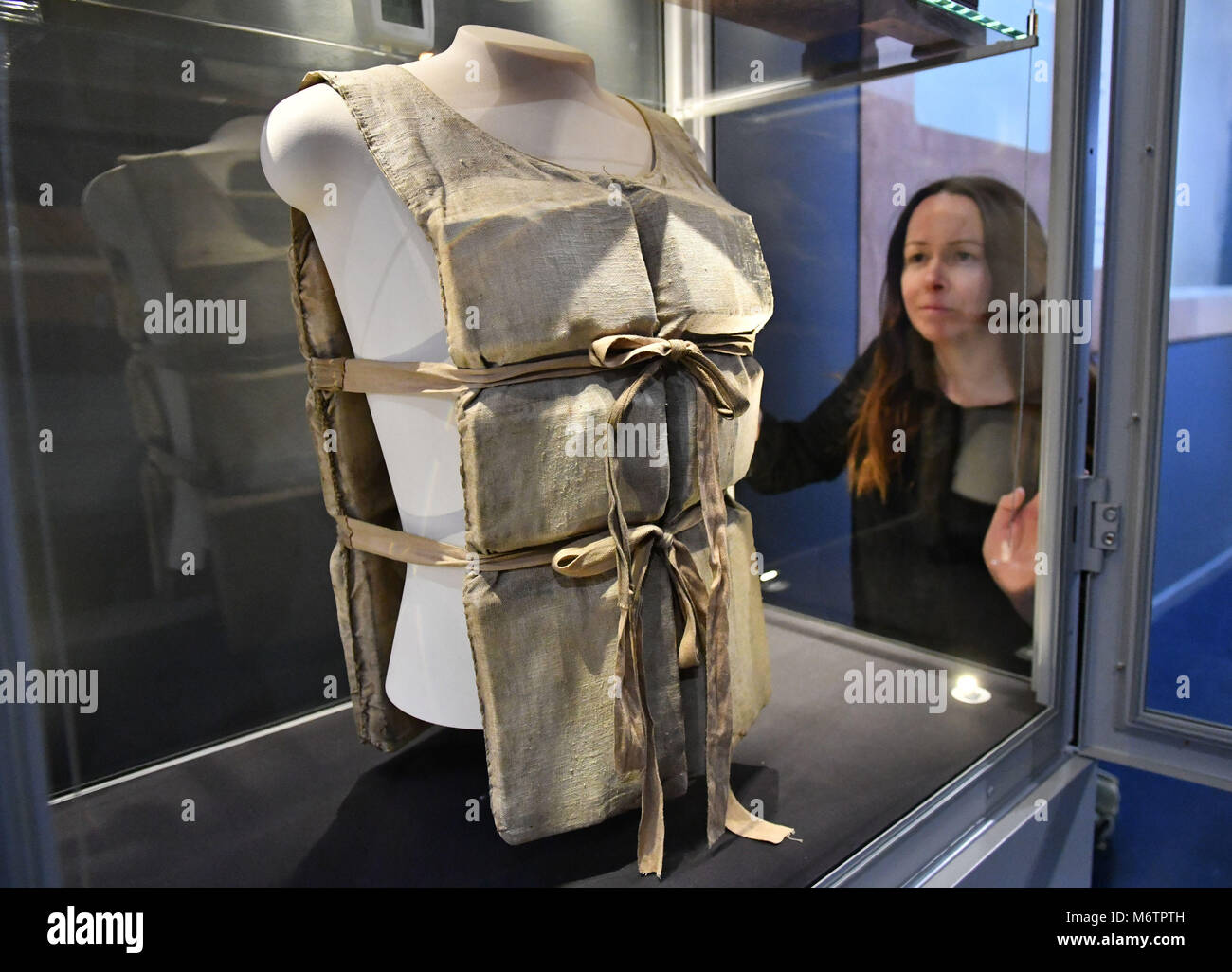 Lauren Hogan looks at lifebelt from RMS Titanic that was given to Carpathia waiters Earnest Gill, during a preview of the Titanic Stories exhibition at the National Maritime Museum Cornwall, Falmouth, which opens on March 8. Stock Photo