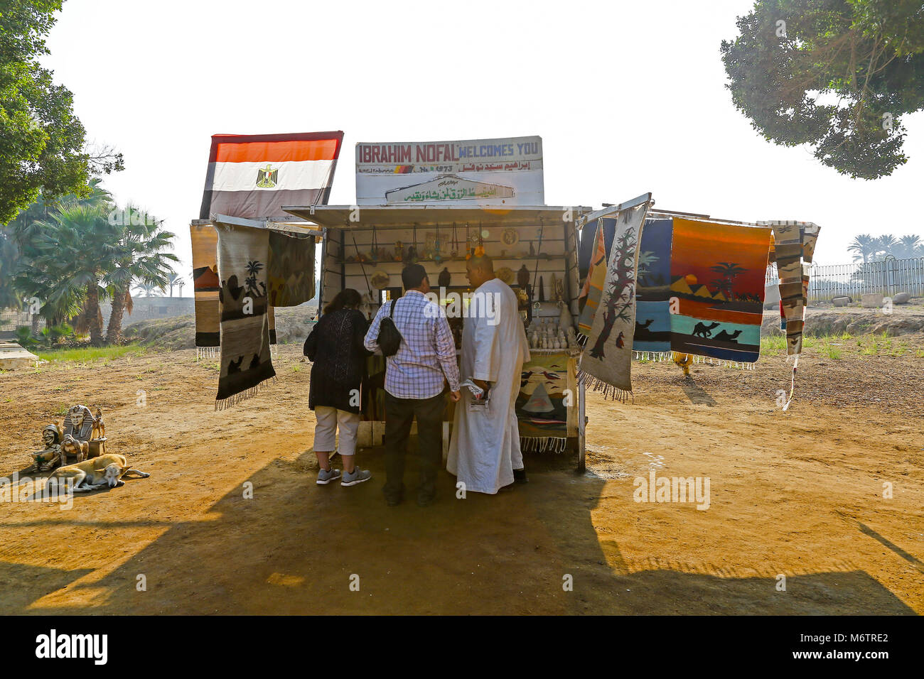 Egyptian souvenir sellers at a stall selling tourists mementoes at the open air museum at Memphis, Egypt, North Africa Stock Photo