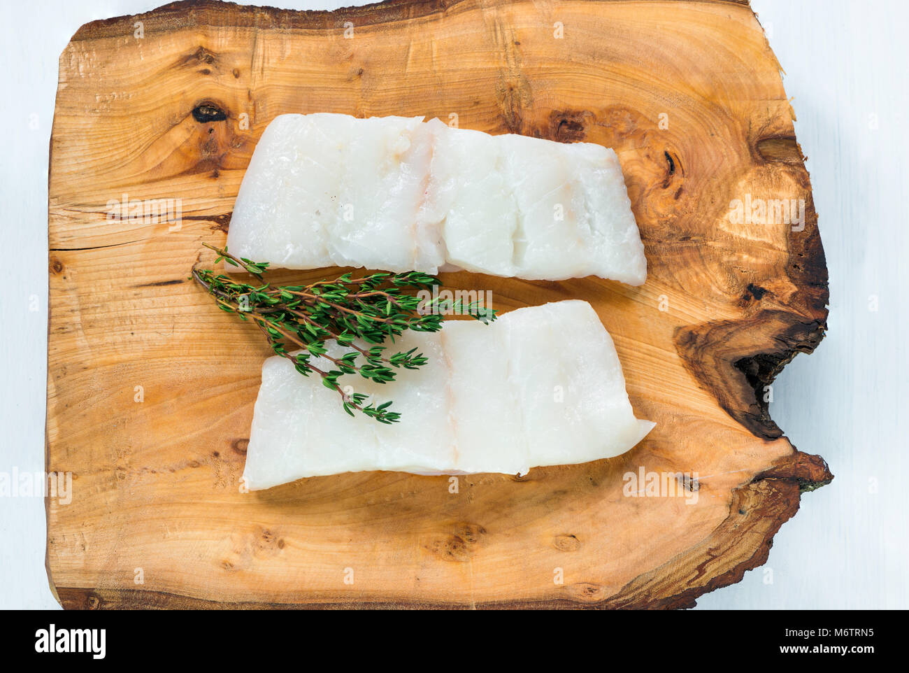 Raw haddock fillets on wooden board top view Stock Photo Alamy