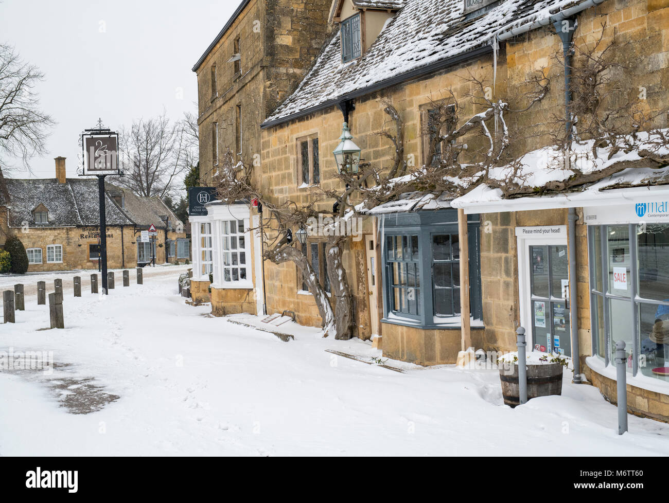 Shops in broadway in the winter snow. Broadway, Cotswolds