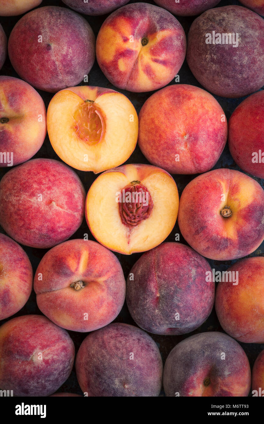 Prunus persica. Peaches pattern on a slate background Stock Photo