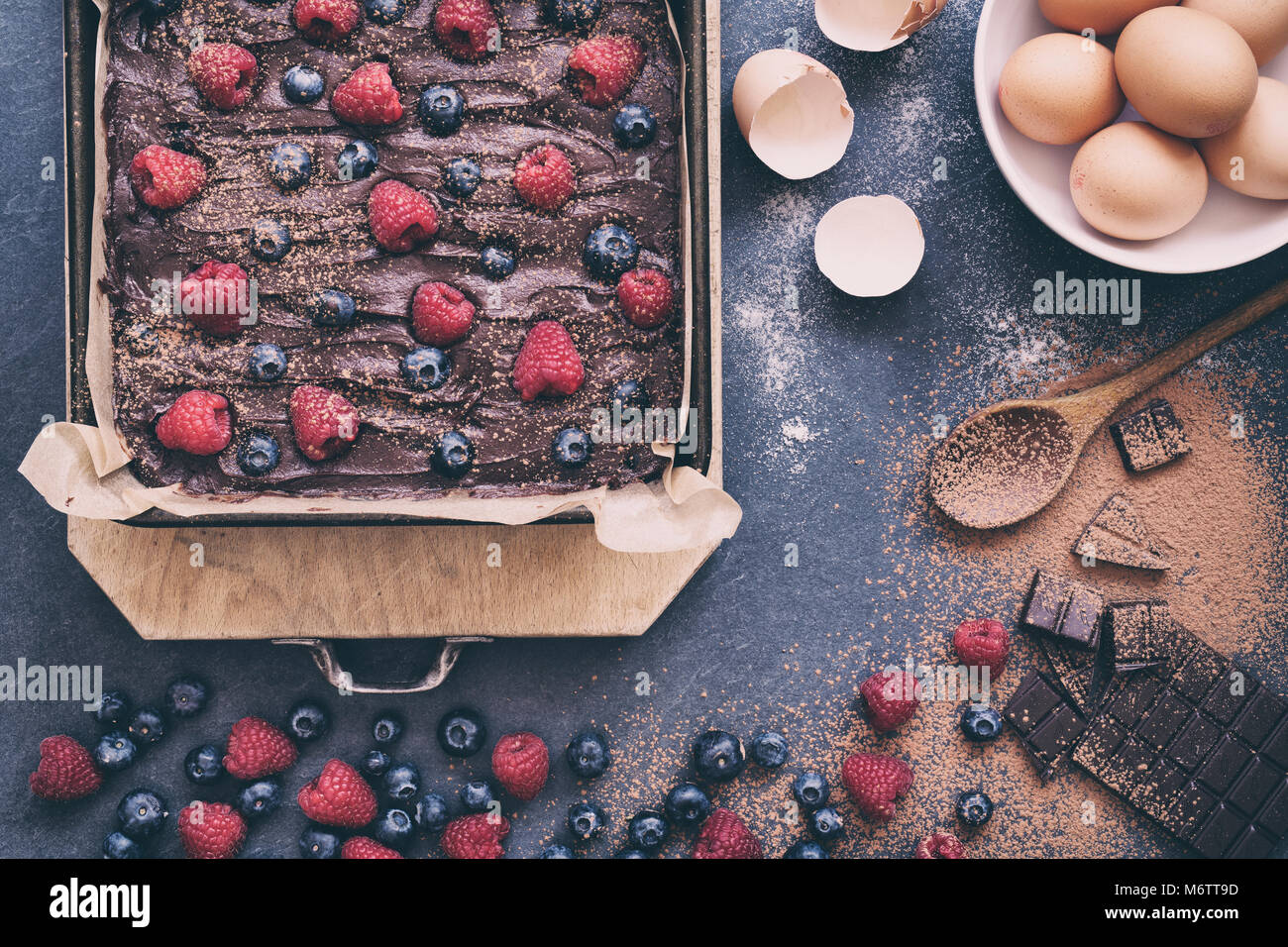 Homemade raw chocolate raspberry and blueberry brownie mixture in a
