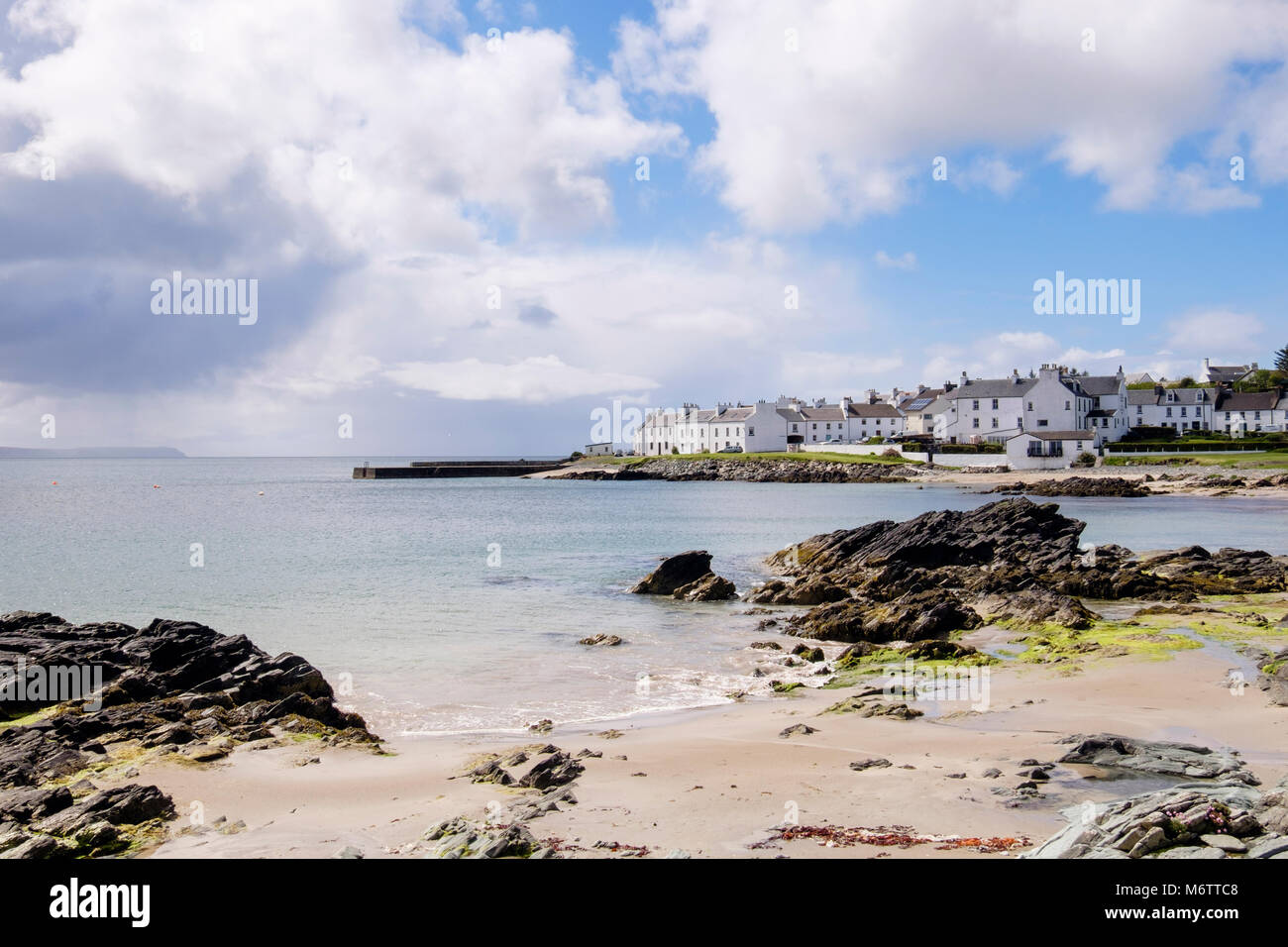 View along small sandy beach on rocky coast of Loch Indaal to Port Charlotte Isle of Islay Argyll and Bute Inner Hebrides Western Isles Scotland UK Stock Photo