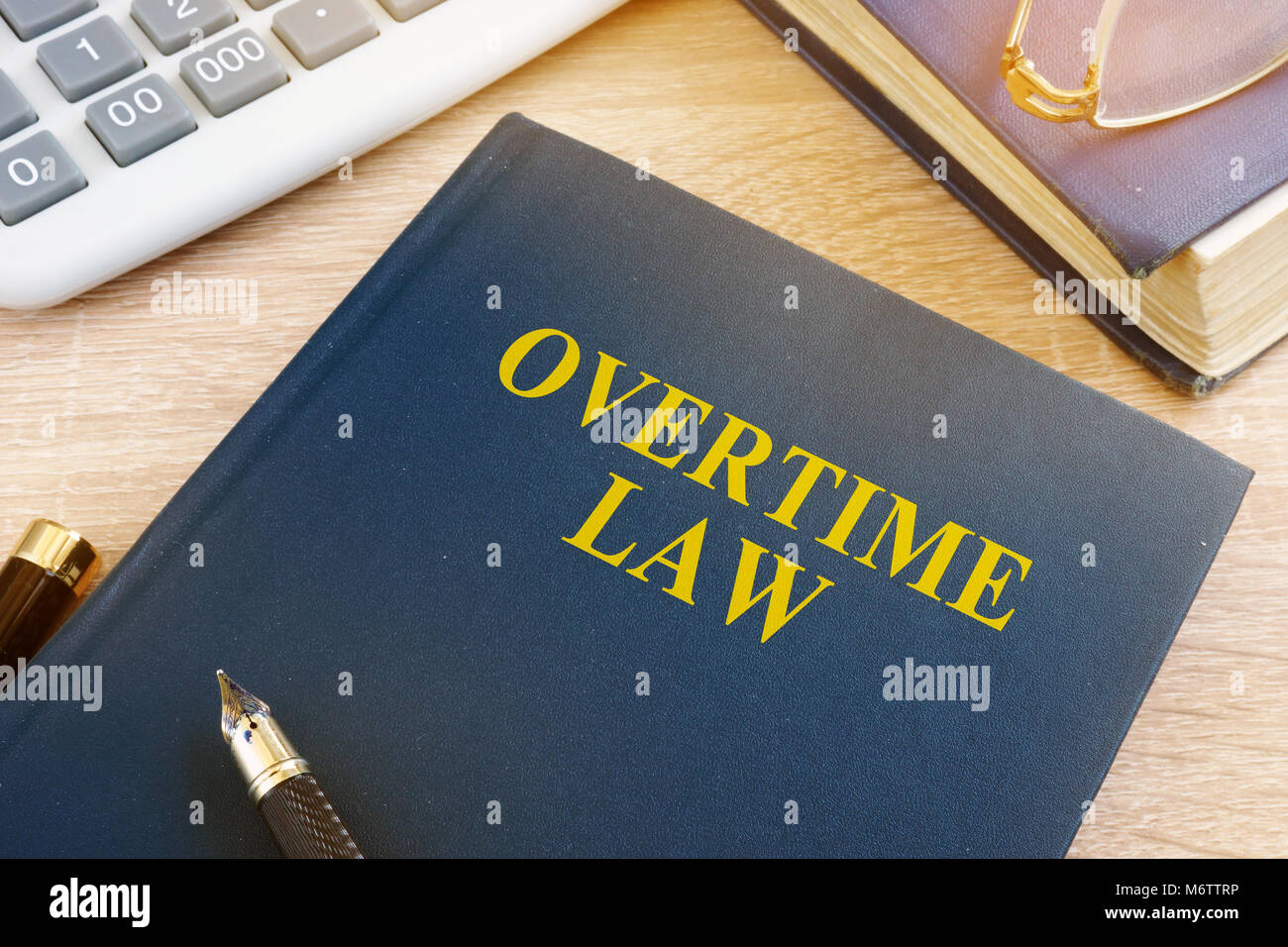 Overtime law and calculator in an office. Stock Photo