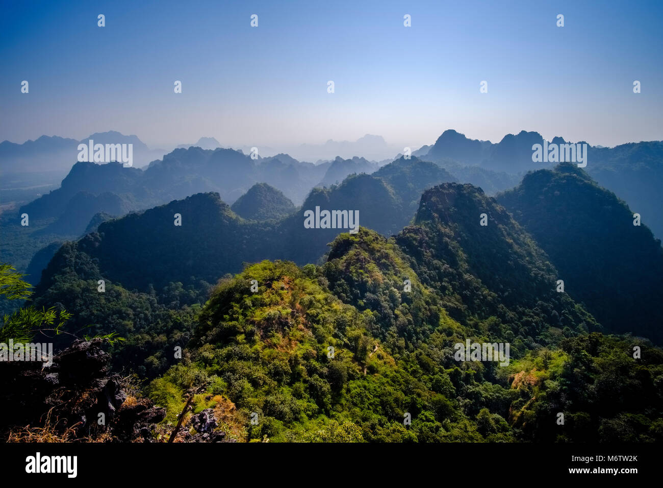 Aerial view on a rugged mountain range, seen from Mt. Zwegabin after sunrise Stock Photo