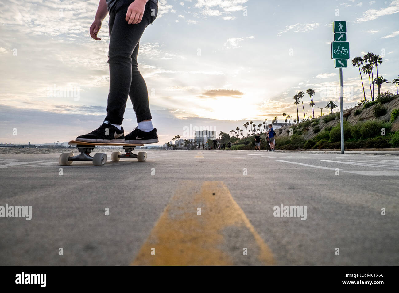 Low view of skaters feet at Long Beach coming towards camera Stock Photo
