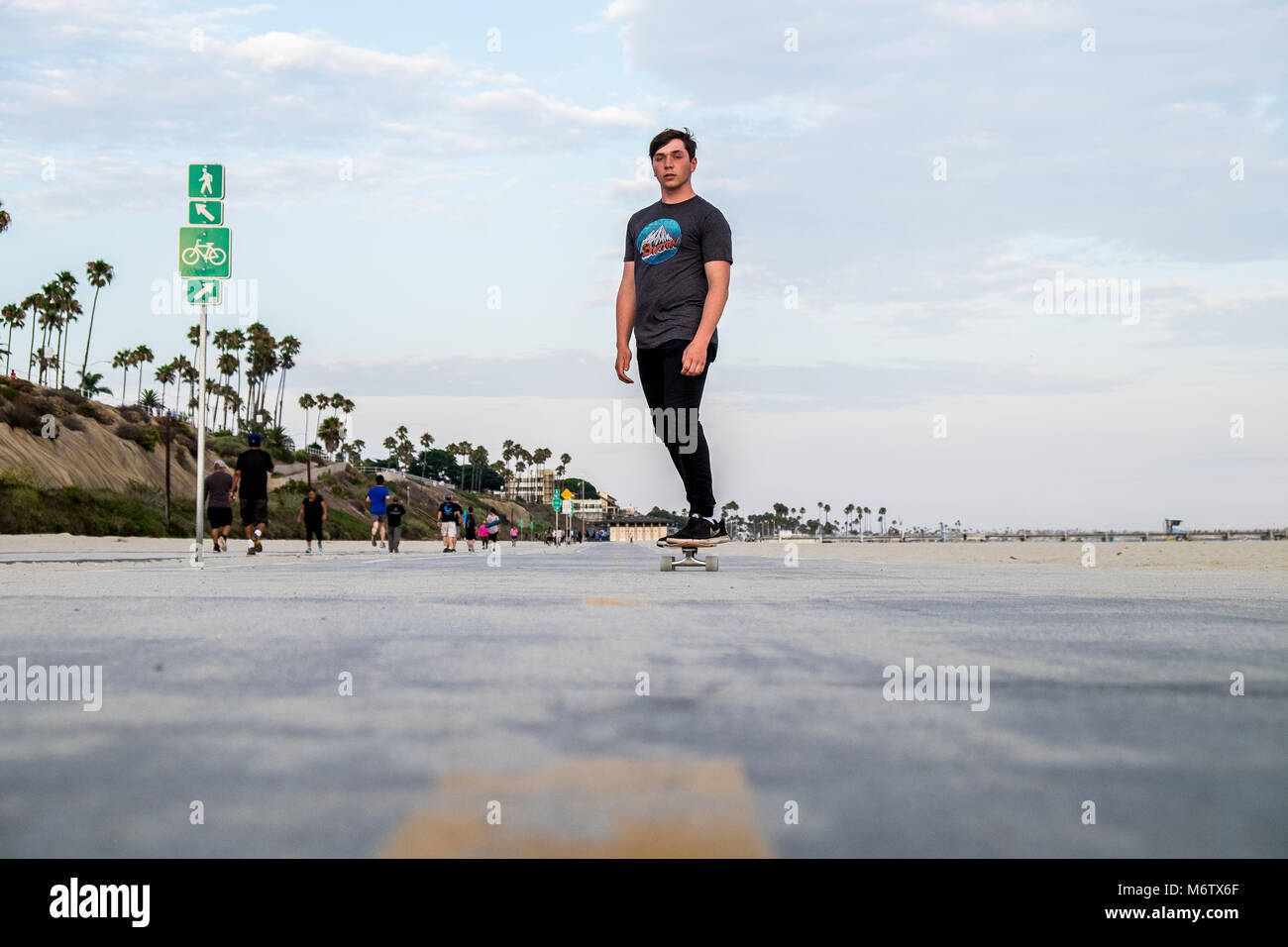 Low view of skater at Long Beach coming towards camera Stock Photo