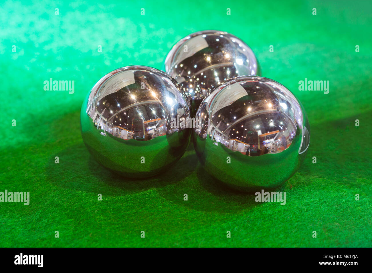 the three steel balls on green background Stock Photo Alamy