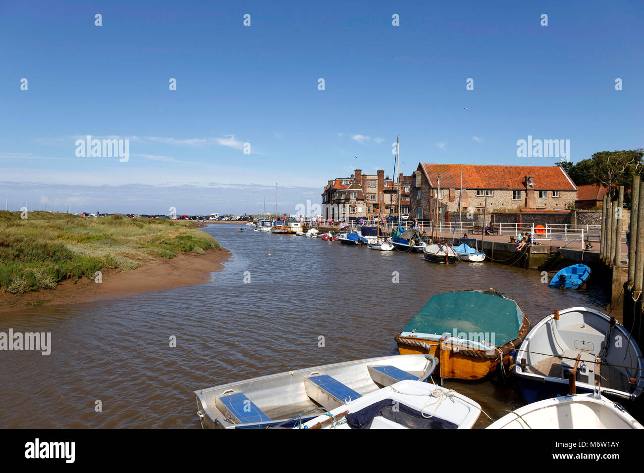Blakeney was a commercial seaport until the early 20th century. Now the harbour is silted up, and only small boats can make their way out Stock Photo