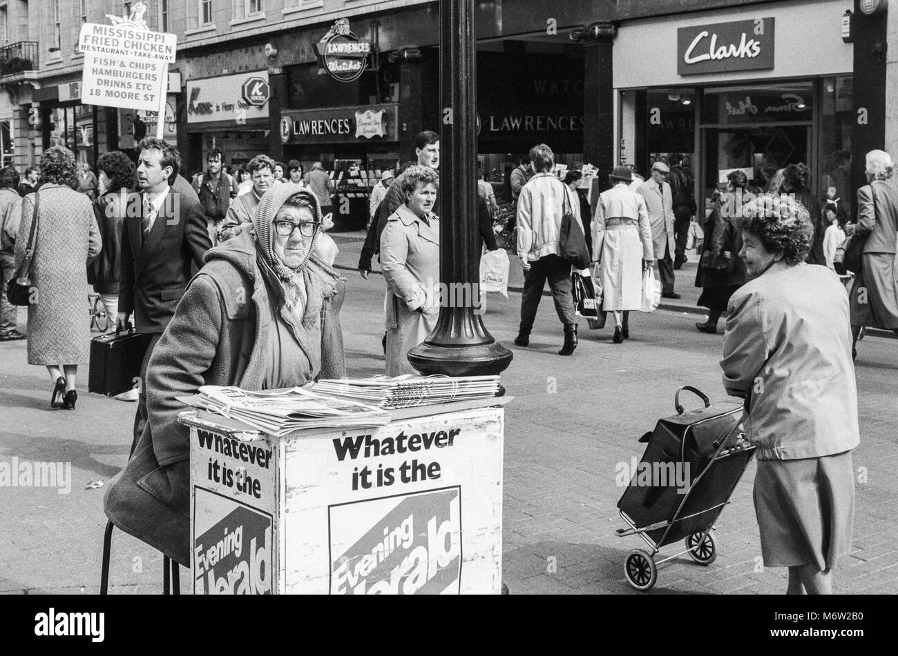 Newspaper seller on Henry Street in Dublin city center, Ireland, Archival photograph from 1988, Stock Photo
