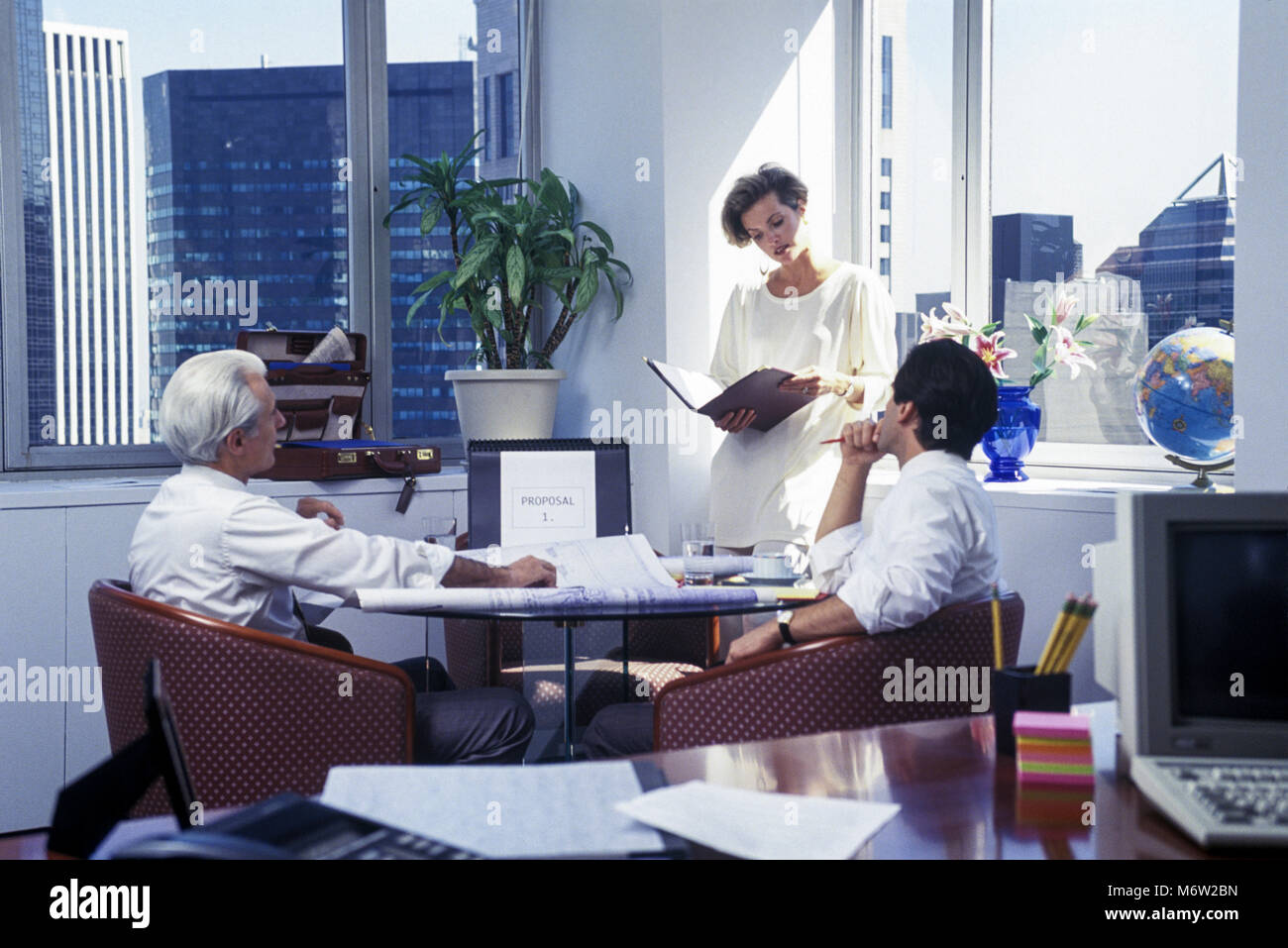 1994 HISTORICAL CAUCASIAN BUSINESS PEOPLE MEETING AROUND TABLE IN ...