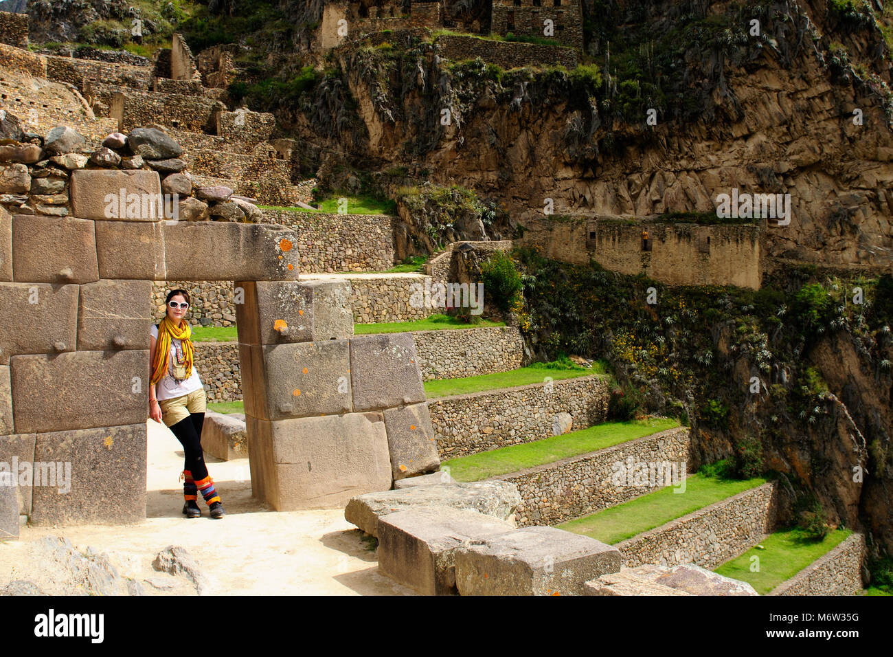 Tourist in the Ollantaytambo incan fortress ruins, remote, spectacular the Inca ruins near Cuzco. Cultivated terrace fields on the steep sides Stock Photo