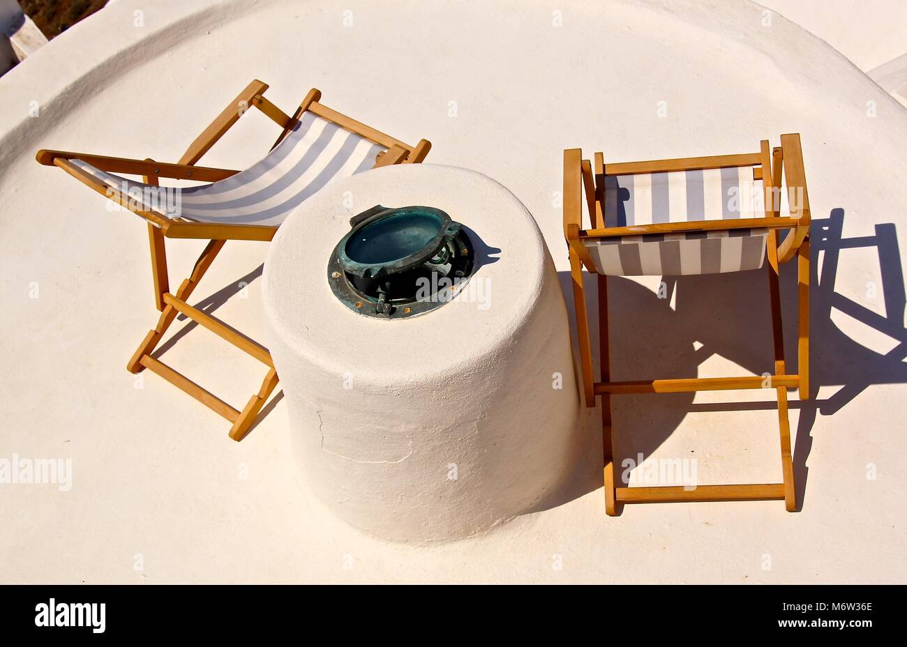 Reclining chairs on patios on Santorini, Greece Stock Photo