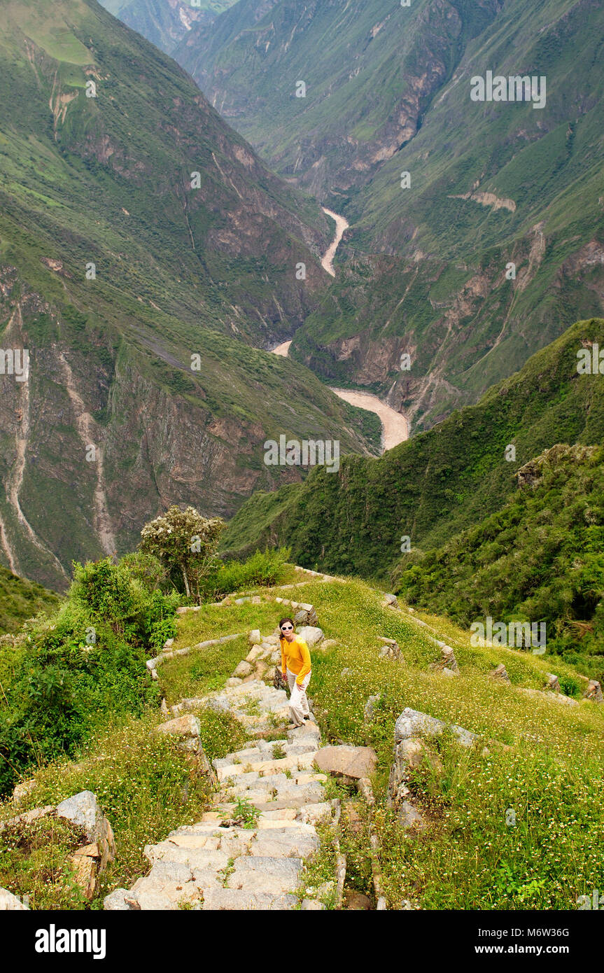 Tourist in the  Choquequirao lost ruins, remote, spectacular the Inca ruins near Cuzco. Cultivated terrace fields on the steep sides of a mountain, Stock Photo