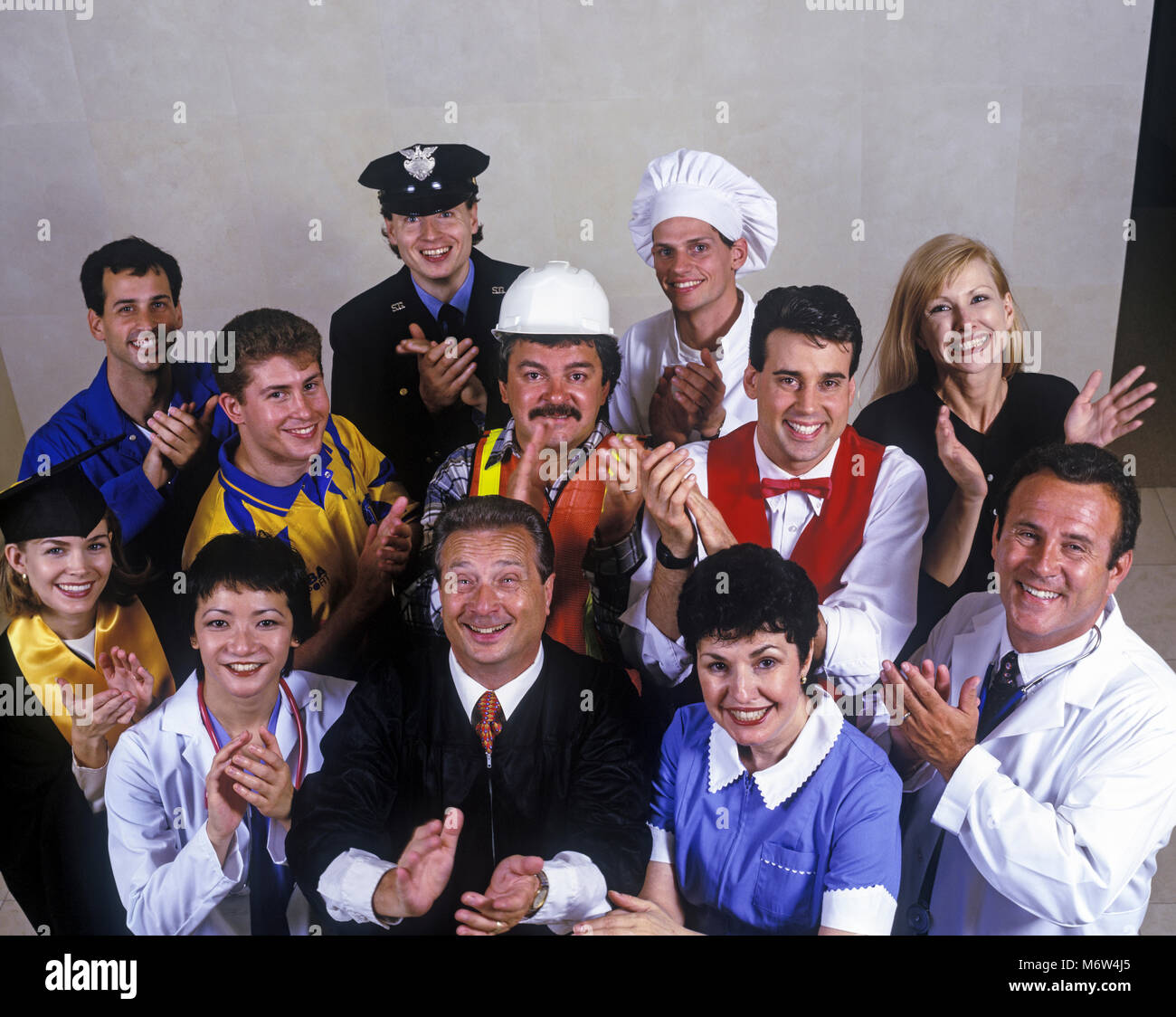 1996 HISTORICAL MULTI-ETHNIC OCCUPATIONS GROUP CLAPPING Stock Photo