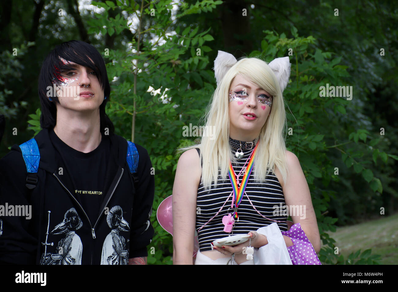 Goth looking young couple in park,breaking male gender stereotype.LGBT pride,Stoke on Trent,Uk.Cosplayers,face painting,diversity,trend.24 June 2017. Stock Photo