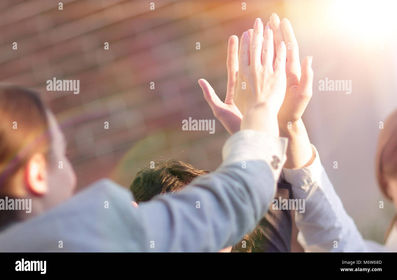 successful business team giving each other a high five Stock Photo - Alamy