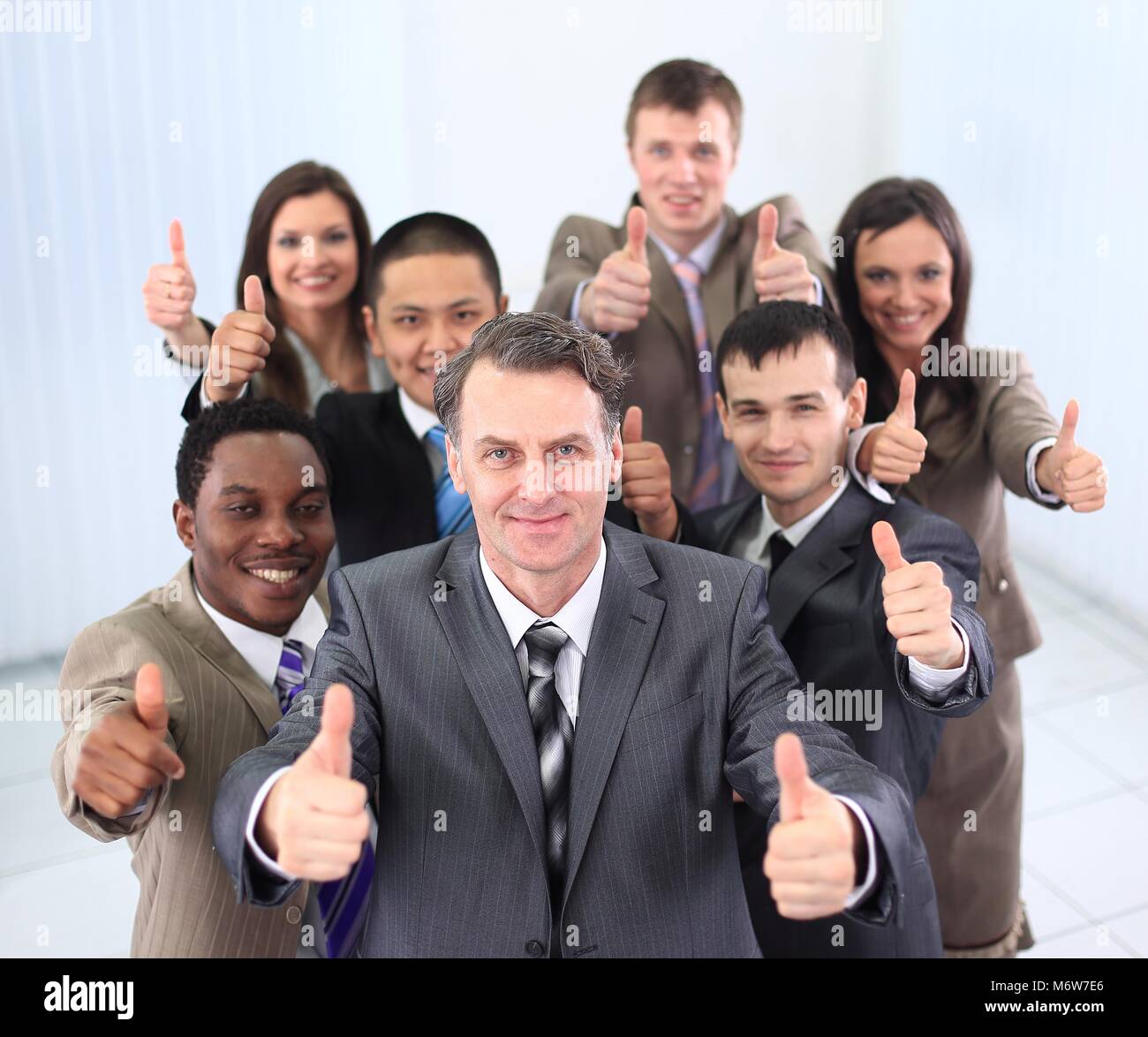 happy business team holding thumbs up Stock Photo - Alamy