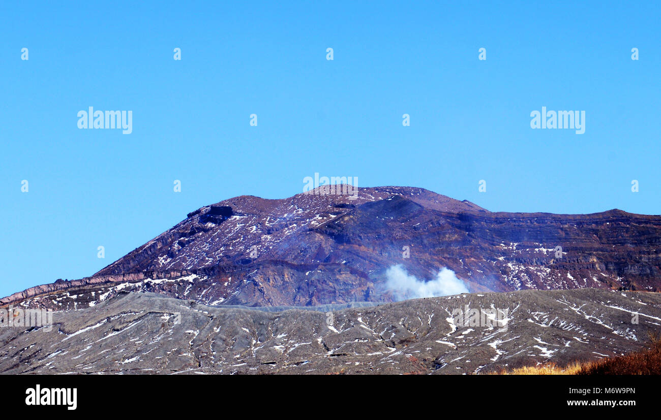 Mt. Aso volcano with the Nakadake crater spewing sulfur steam. Stock Photo