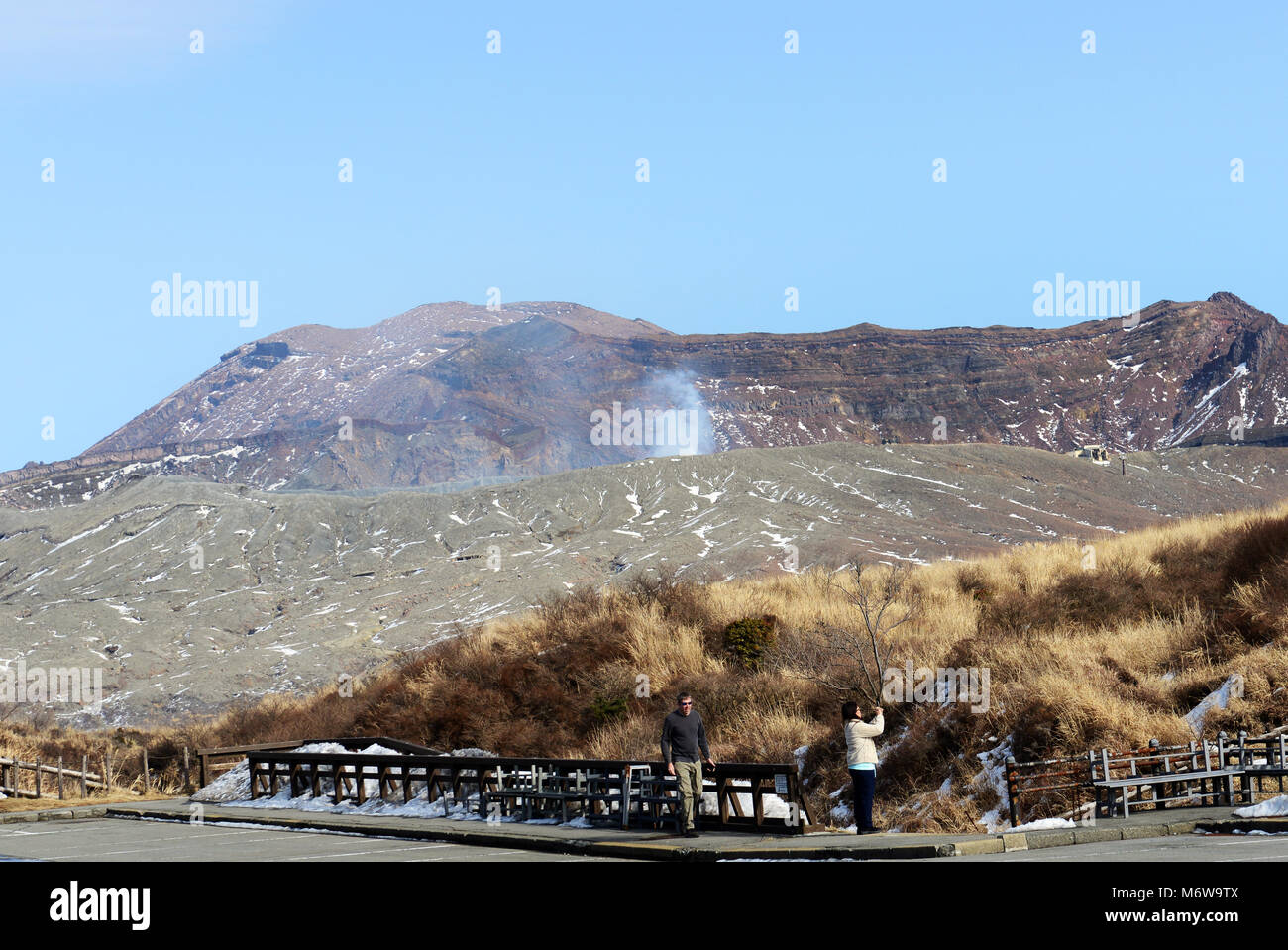 Mt. Aso volcano with the Nakadake crater spewing sulfur steam. Stock Photo