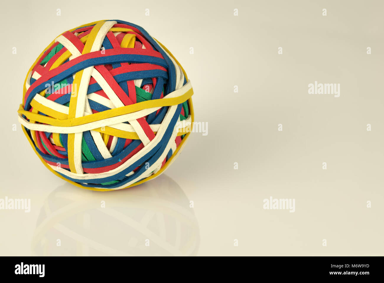 Rubber band ball made from many colourful elastic bands isolated on a