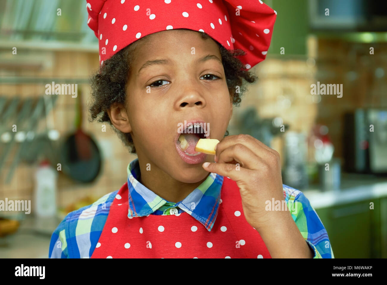 Afroamerican kid eating apple. Stock Photo