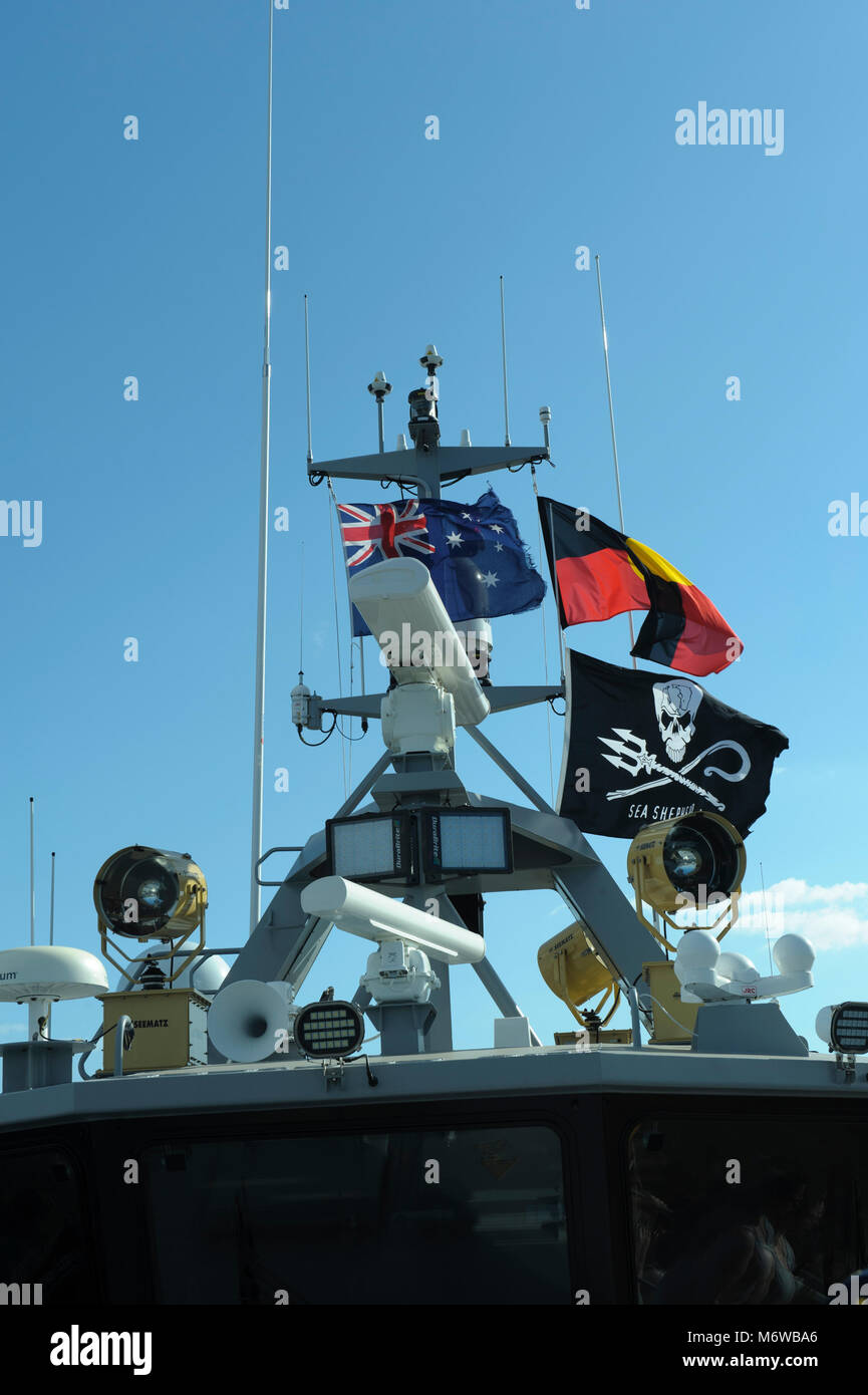Electronics equipment atop the bridge of Sea Shepherd's 'Ocean Warrior', flying the Sea Shepherd, Australian, and the Australian Aboriginal flags Stock Photo