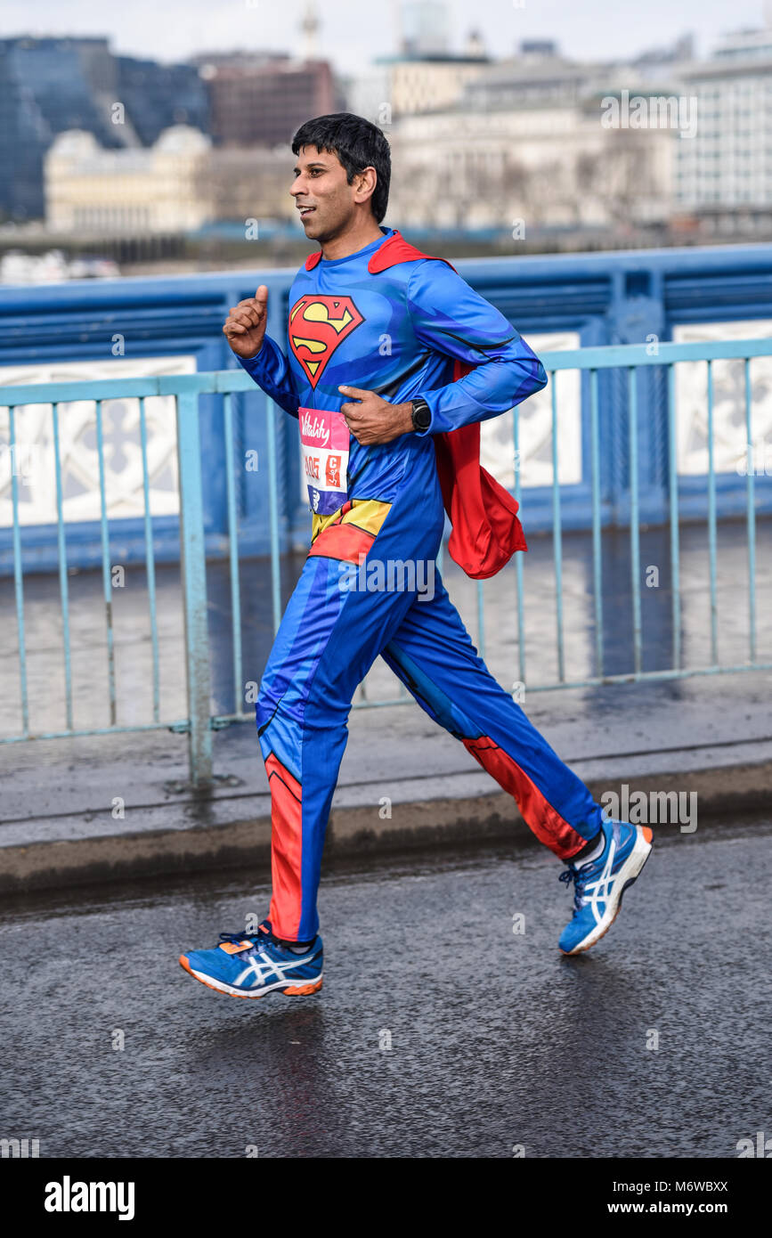 Rav Singh 2105 running as Superman in the Vitality Big Half marathon crossing Tower Bridge, London. Space for copy Stock Photo