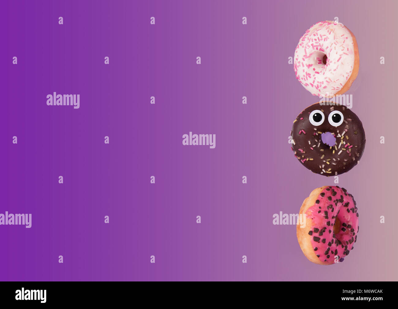Colorful glazed donuts in motion with funny eyes Stock Photo Alamy