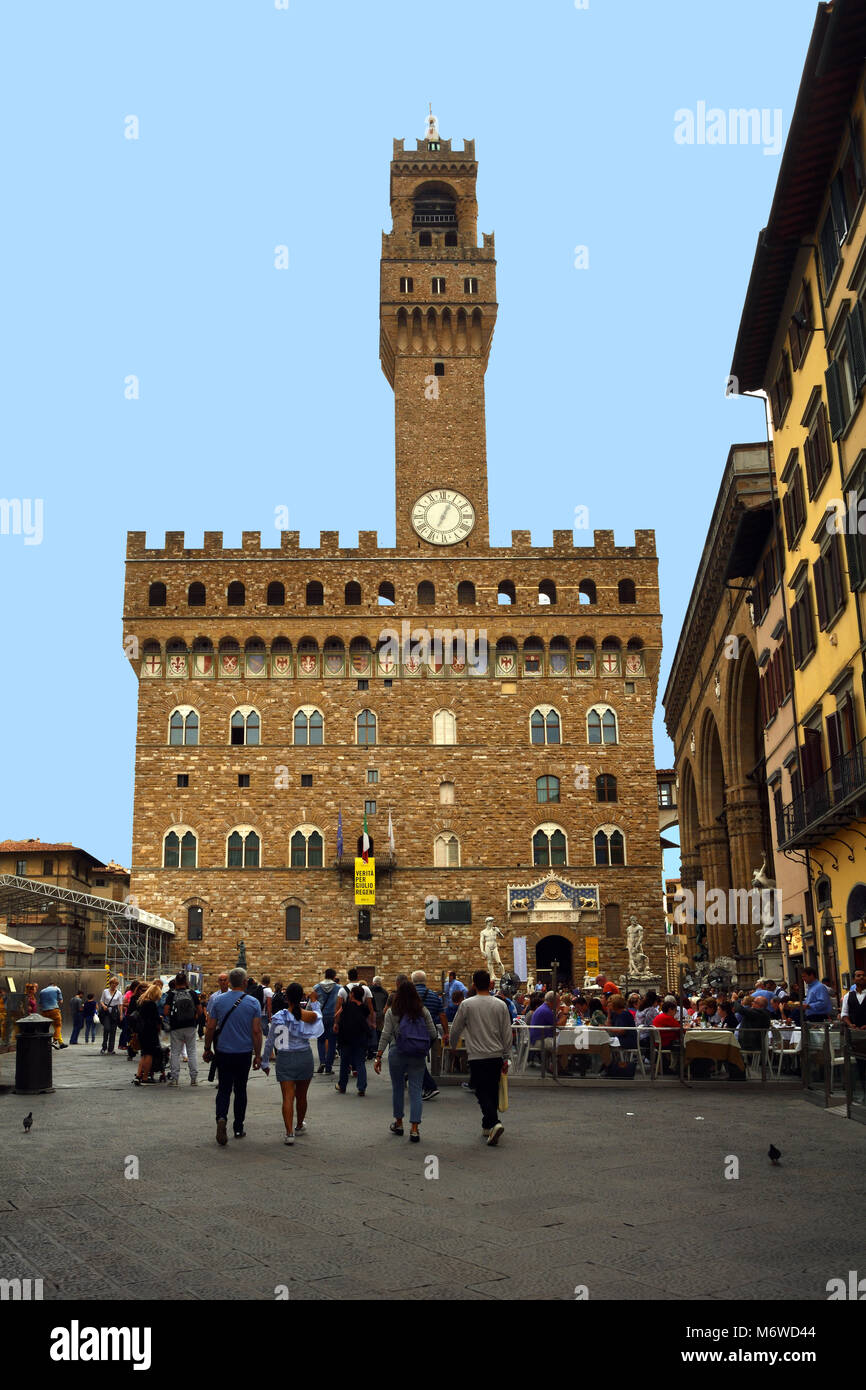 Tourists in the Piazza della Signoria in front of the Palazzo Vecchio in the historic center of Florence - Italy. Stock Photo