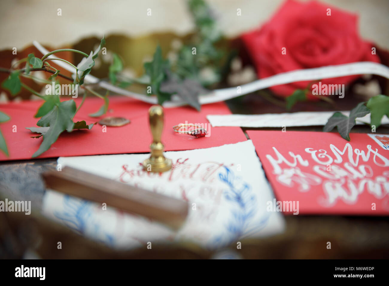 Wedding details calligraphy with flower on wood background Stock Photo