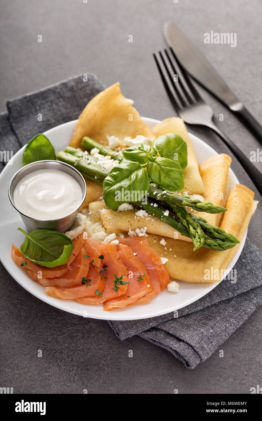 Savory crepes with salmon, sour cream, feta and asparagus Stock Photo
