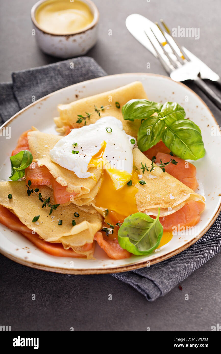 Savory crepes with salmon and poached egg Stock Photo Alamy
