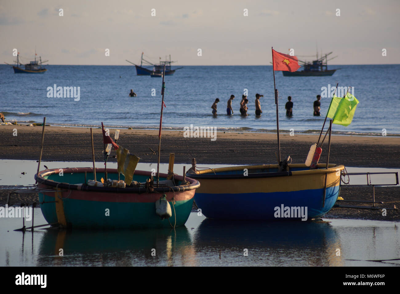 Vietnamese fishing boat silhouettes in sea at sunset Stock Photo - Alamy