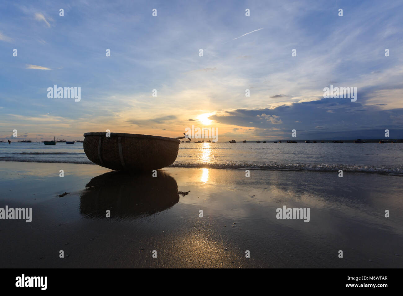 Vietnamese fishing boat silhouettes in sea at sunset Stock Photo - Alamy