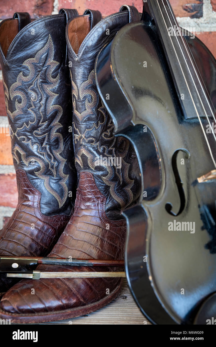 Well-worn cowboy boots and fiddle, Nashville, Tennessee, USA Stock Photo