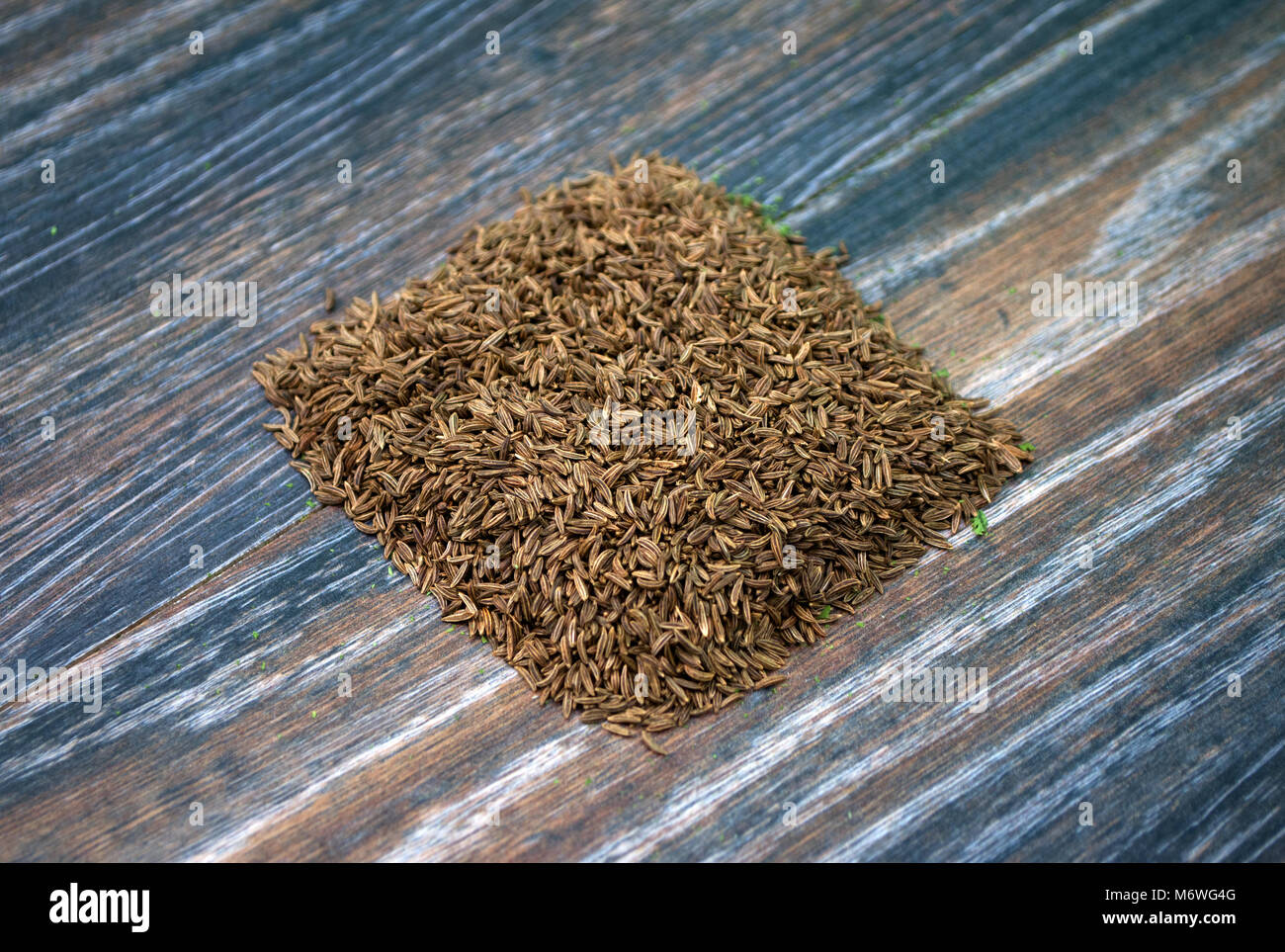 Various forms of carum carvi on a wooden background Stock Photo