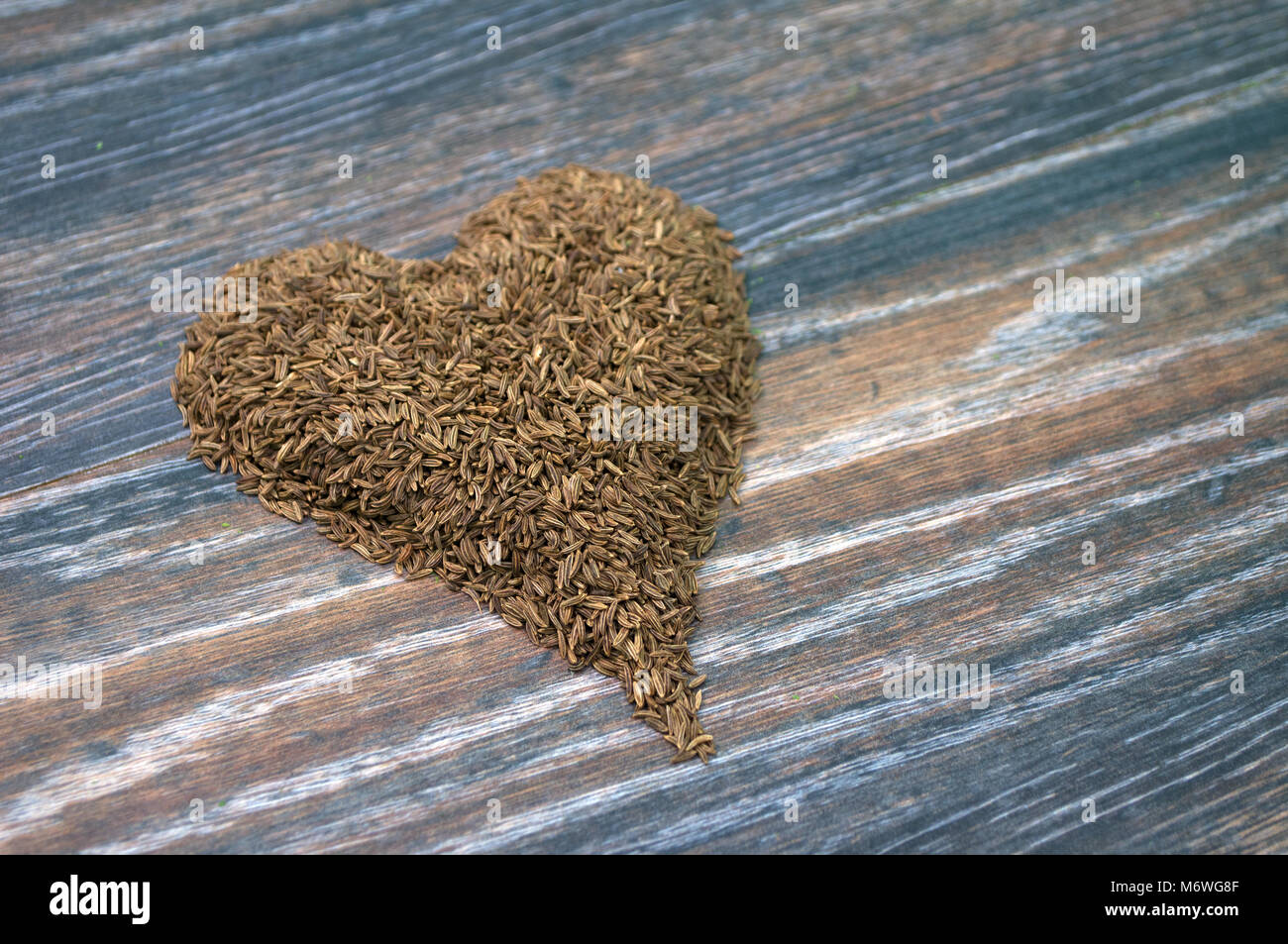 Various forms of carum carvi on a wooden background Stock Photo